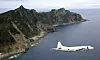 Japan Maritime Self-Defense Force P-3C Orion surveillance plane flies over the disputed islands, called the Senkaku in Japan and Diaoyu in China, in the East China Sea, on Oct. 13, 2011. [AP/YONHAP]