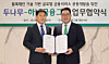 Hana Financial Group Vice Chairman Lee Eun-hyung, right, and Dunamu CEO Oh Kyoung-suk pose for a photo after signing an agreement that will see the firms jointly develop financial services using blockchain technology at Hana Financial Group's office in Myeong-dong, central Seoul, on Dec. 3. [HANA FINANCIAL GROUP]