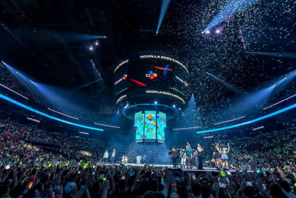 K-pop stars perform under bright stage lighting at KCON 2023 held at the Crypto.com Arena in downtown Los Angeles