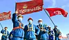North Korean shock troops hold up flag while participating in the construction of 10,000 homes in the Hwasong area in Pyongyang. [RODONG SINMUN]