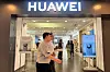 People walk past a Huawei store with advertisements for the Mate 60 series smartphones, at a shopping mall in Beijing, China August 30, 2023. [REUTERS]