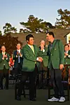 Scottie Scheffler shakes hands with Hideki Matsuyama after receiving the Green Jacket following his three stroke victory following the final round of the Masters Tournament at Augusta National Golf Club in Augusta, Georgia on April 10, 2022. [GETTY IMAGES]