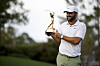 Scottie Scheffler poses for a photo as he holds the winner's trophy after winning The Players Championship at Stadium Course at TPC Sawgrass on March 17, 2024 in Ponte Vedra Beach, Florida. [GETTY IMAGES]