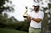Scottie Scheffler poses for a photo as he holds the winner's trophy after winning The Players Championship at Stadium Course at TPC Sawgrass on March 17, 2024 in Ponte Vedra Beach, Florida. [GETTY IMAGES]