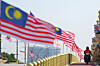 A motorcyclist rides past Malaysia national flags ahead of Malaysia Independence Day celebrations in Putrajaya, Malaysia on Aug. 19, 2025. [EPA/YONHAP]