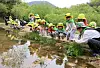 Children observe wetland creatures including frogs and tadpoles at Pyeongdume Wetland in Gwangju on April 22, during an outdoors activity in celebration of Earth Day. [YONHAP]