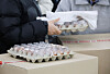 A carton of eggs is seen held by a cafeteria worker at a school in Daejeon on Dec. 4. [YONHAP]