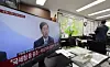 A television at a real estate agency in Seoul airs a government announcement on measures to stabilize the housing market on Oct. 15. All 25 districts in Seoul and 12 areas in Gyeonggi Province were designated as regulated zones, including speculative and overheated speculation areas. [YONHAP]