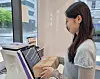 A customer sends a package through convenience store chain CU, operated by BGF Retail, which launched a next-day delivery service on April 14. [CU]