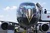 A person stands by an Embraer E2 on display at the Paris Air Show, June 16, in Le Bourget, north of Paris. [AP/YONHAP]