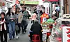Shoppers walk past vendors at a traditional market in Jongno District, central Seoul, on April 15. The Korean government announced a supplementary budget aimed at addressing urgent national priorities including small business support on April 18. [NEWS1]