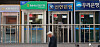 A passerby walks past ATMs in Seoul on April 16. [YONHAP]
