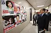 Kwon Young-se, interim leader of the People Power Party, looks over campaign posters of presidential primary candidates as he arrives for an emergency leadership committee meeting at the National Assembly on April 21. [YONHAP]