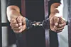 A handcuffed prisoner in jail [GETTY IMAGES BANK]