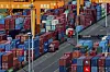 Trucks move amid containers stacked at a container terminal port on the Yangtze River in southwest China's Chongqing Municipality on April 20. [YONHAP/AP]