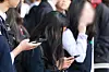 A student uses a smartphone after school at a middle school in Seoul on Nov. 4, 2024. [YONHAP]