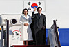 President Lee Jae Myung, right, and first lady Kim Hea Kyung are seen departing for Shanghai from Beijing on Jan. 6. [JOINT PRESS CORPS]
