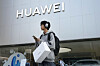 A customer carries a Huawei product outside a Huawei store after attending the company's new product launch conference in Beijing on Sept. 25, 2023. [AP/YONHAP]