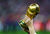 The World Cup trophy is lifted up during the closing ceremony before the match between Argentina and France on Dec. 18, 2022. [REUTERS/YONHAP]