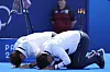 Korea's Kim Woo-jin, right, and coach Park Seong-su bow deeply to fans after Kim won gold in the men's individual archery final in Paris on Sunday. [AP/YONHAP]