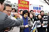Rep. Back Hye-ryun of the main opposition Democratic Party wipes her face after she was hit by a raw egg thrown by an unidentified person outside the Constitutional Court in Seoul on March 20. [YONHAP]