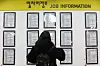 A job hunter looks at job applications at an employment center in Mapo District, central Seoul, on March 17. [YONHAP]