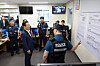 President Lee Jae Myung, left, is briefed about public security and safety efforts over the Chuseok holiday by police officers at a police station in central Seoul on Oct. 3. [PRESIDENTIAL OFFICE]
