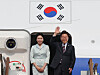 President Lee Jae-myung, right, and first lady Kim Hye-kyung greet onlookers at Seoul Air Base in Seongnam, Gyeonggi, before boarding the presidential jet bound for Canada on June 16. [YONHAP]