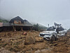 A house with a torn brick wall and a damaged car stands in mid-hill Naeri, Sancheong-eup, around 9:40 a.m. on July 20, following the previous day’s landslide. [KIM MIN-JU]