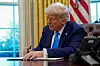 U.S. President Donald Trump signs a document in the Oval Office at the White House in Washington on Feb. 4. [REUTERS/YONHAP]