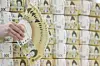 A Hana Bank official holds up 50,000 won ($36) bills at the bank's office in Jung District, central Seoul, on Feb. 19. [NEWS1]