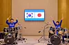 President Lee Jae Myung, left, and Japanese Prime Minister Sanae Takaichi don matching jackets and play a drum duet in Nara, Japan, on Jan. 13. The surprise K-pop drum performance, featuring BTS’s hit “Dynamite,” capped their summit with a show of personal rapport and future-oriented cooperation. [JOINT PRESS CORPS]