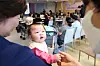 A baby holds an adult's hand during an education session for pregnant women at a hospital in Goyang, Gyeonggi. [YONHAP]