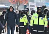 A foreigner, far left, walks by police positioned in Gwanghwamun in central Soul Wednesday, a day after President Yoon Suk Yeol's declaration of emergency martial law. [YONHAP]