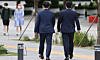 Office workers in suits walk across a street in Jongno District, central Seoul in this file photo [YONHAP]