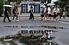 Tourists walk across rain-soaked ground with parasols at Imjingak in Paju, Gyeonggi, on July 1. [YONHAP]