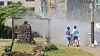 Citizens walk by a cooling fog spray at the Jaguri Park in Jeju Island on July 18. [YONHAP]