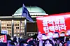 People participating in a candlelight march chant slogans urging the passage of the impeachment motion against President Yoon Suk Yeol on Saturday in front of the National Assembly in western Seoul. [KIM JONG-HO]