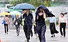 Citizens walk through the rain in central Seoul on July 14. [NEWS1]