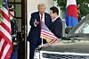 Korean President Lee Jae Myung, right, waves as he is greeted by U.S. President Donald Trump ahead of their first bilateral summit at the White House in Washington on Aug. 25. [JOINT PRESS CORPS]