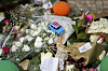 A toy with the United Kingdom flag is placed among the flowers of a tribute to those that perished in the Gloria funicular, a tourist streetcar that derailed and crashed, in Lisbon, Portugal, on Sept. 6. [AP/YONHAP]