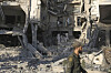 A soldier passes in front the damaged Syrian Defense Ministry building allegedly hit by several Israeli airstrikes, in Damascus, Syria, July 16. [AP/YONHAP]