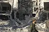 A soldier passes in front the damaged Syrian Defense Ministry building allegedly hit by several Israeli airstrikes, in Damascus, Syria, July 16. [AP/YONHAP]