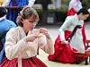 A foreign tourist participates in a traditional coming-of-age ceremony during the 2024 Hanbok Culture Week at the National Folk Museum of Korea in Jongno District, central Seoul, on Oct. 14. [NEWS1]