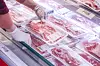 An employee arranges pork belly at a large supermarket in Seoul on April 13. [NEWS1]