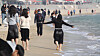 Tourists walk barefoot at Haeundae Beach in Busan on Jan. 23. [NEWS1]