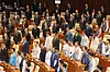 Democratic Party lawmakers in hanbok (traditional Korean dress) and People Power Party lawmakers in black mourning attire sing the national anthem during the opening ceremony of the regular National Assembly session in Yeouido, western Seoul, on Sept. 1. [YONHAP]
