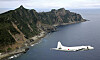 A Japan Maritime Self-Defense Force P-3C Orion surveillance plane flies over the disputed islands, called the Senkaku in Japan and Diaoyu in China, in the East China Sea, on Oct. 13, 2011. [AP/YONHAP]