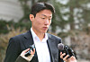 Footballer Hwang Ui-jo answers reporters' questions as he leaves the court after being sentenced to one year in prison and two years of probation in the first trial held at the Seoul Central District Court on Feb. 14. [YONHAP]