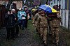 An honor guard carries the coffin of Ruslan Zhygunov, a Ukrainian serviceman, who was killed at the frontline near Rusyn Yar village, during his funeral ceremony in Hostomel, Ukraine, on Nov. 22. [AP/YONHAP]